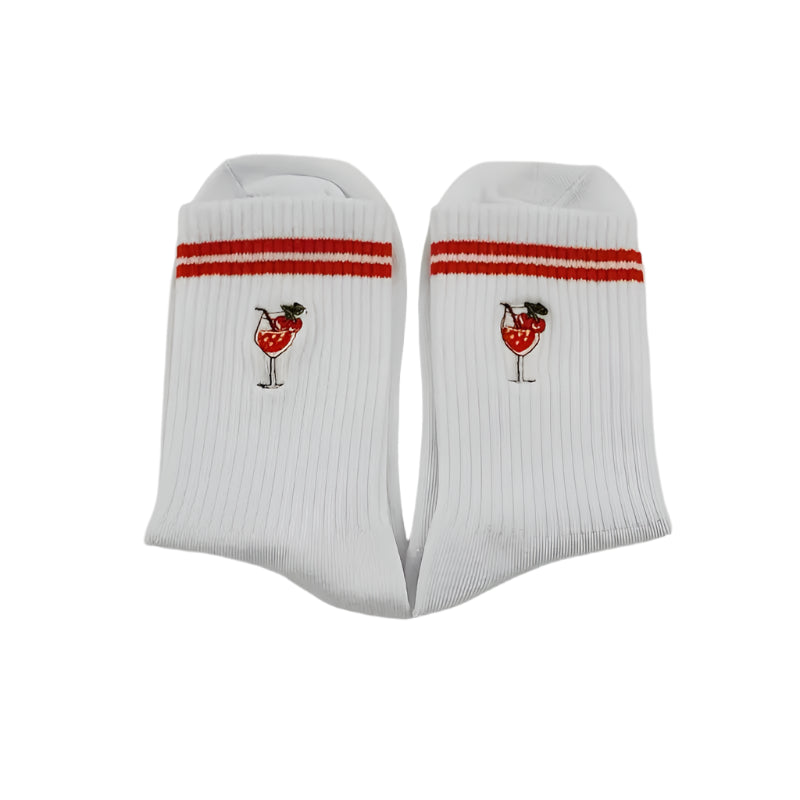 White socks with red and white stripes and a cherry design on a light gray background